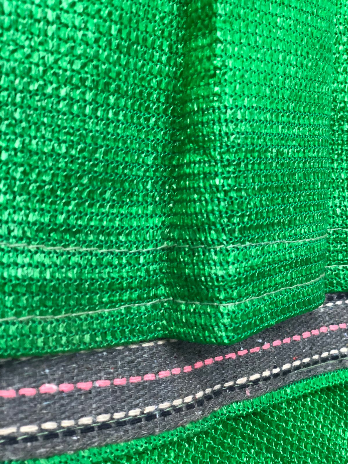 Close-up of knitted HDPE shade net structure showing mesh geometry
