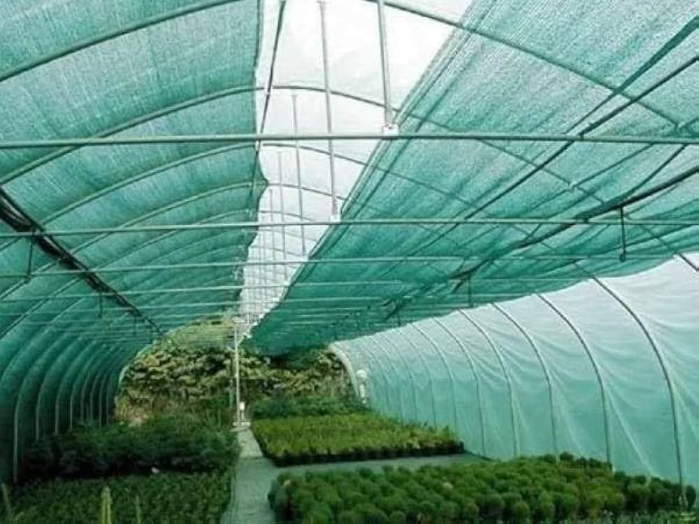 Sunlight filtering through green knitted shade netting